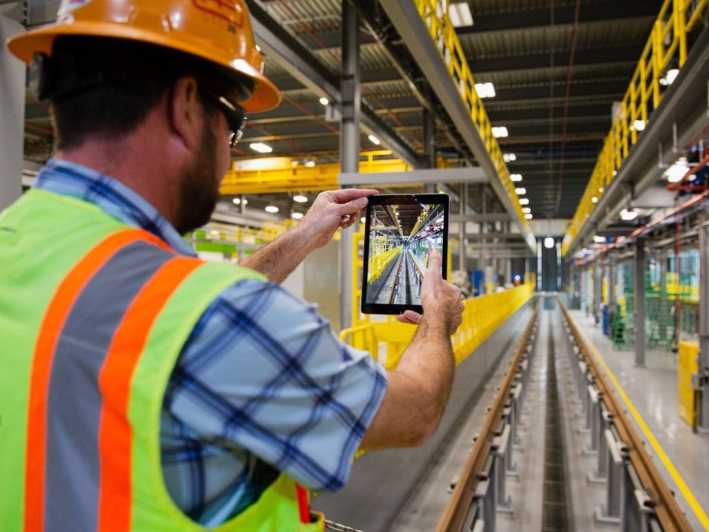 worker taking photo of construction project with tablet.