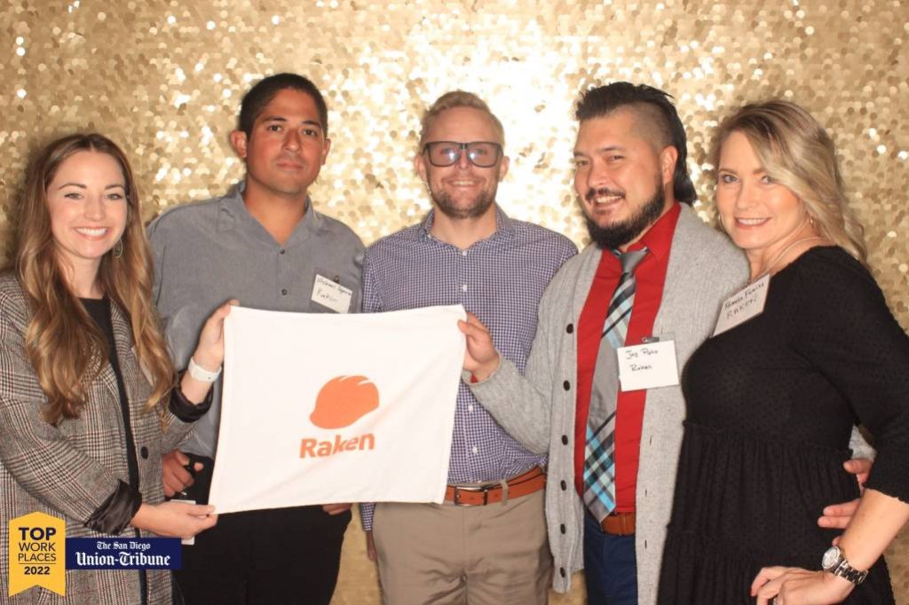 Raken employees posing with Raken towel.
